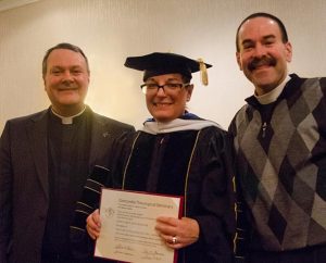 Dr. Maggie Karner stands with the Rev. Dr. Lawrence R. Rast Jr. (left), president of Concordia Theological Seminary, Fort Wayne, Ind., and her husband, the Rev. Kevin Karner, after receiving the Doctor of Humane Letters Honoris Causa Jan. 23. (LCMS/David Yow)